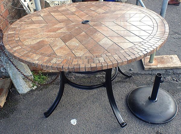 A GARDEN TABLE WITH TILED TOP