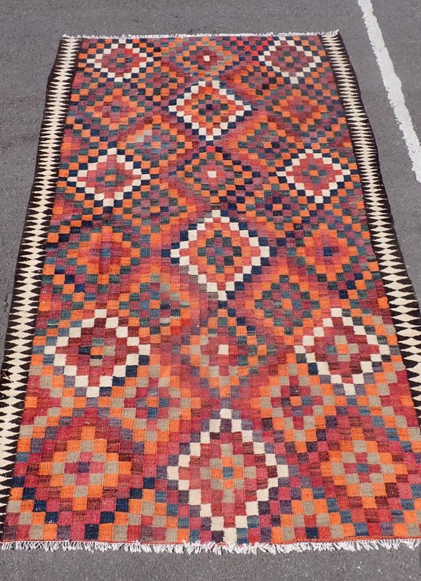 A FLATWEAVE RUG, WITH SQUARED PATTERN