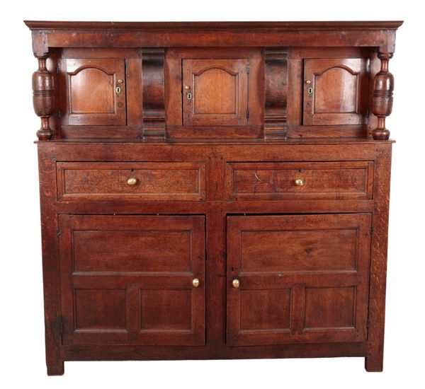 A PANELLED OAK COURT CUPBOARD