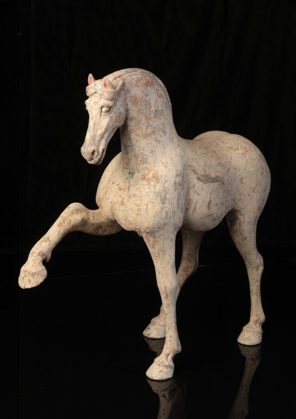 A CHINESE POTTERY PRANCING HORSE
