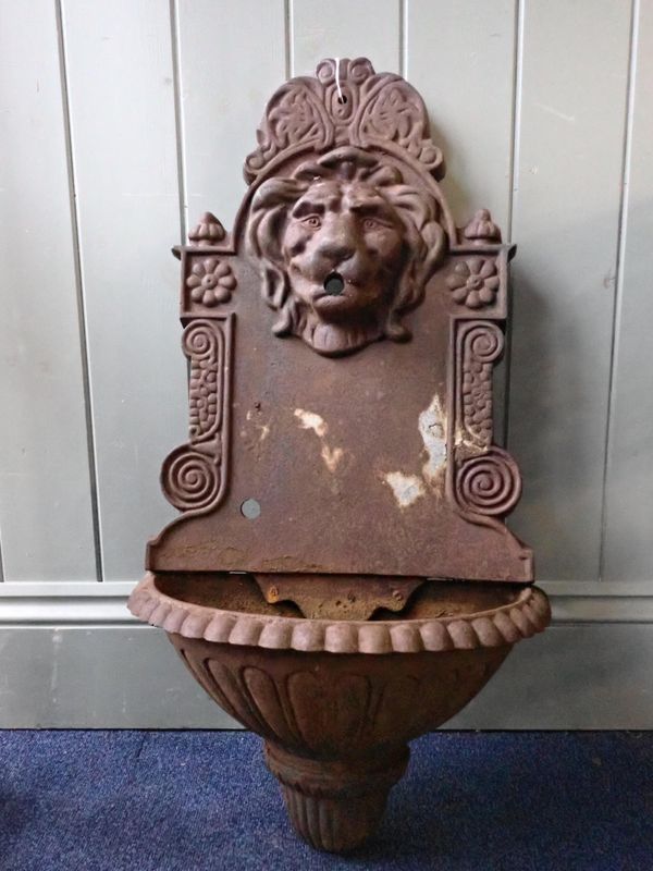 A CAST IRON GARDEN WALL FOUNTAIN