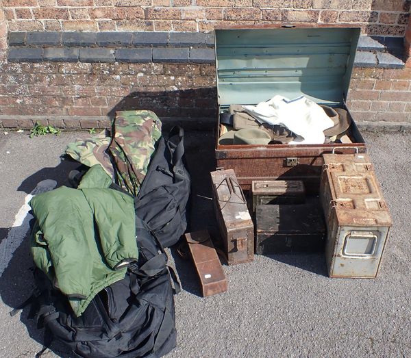 A LARGE TRUNK FILLED WITH MILITARY BED ROLLS, HATS, WEBBING