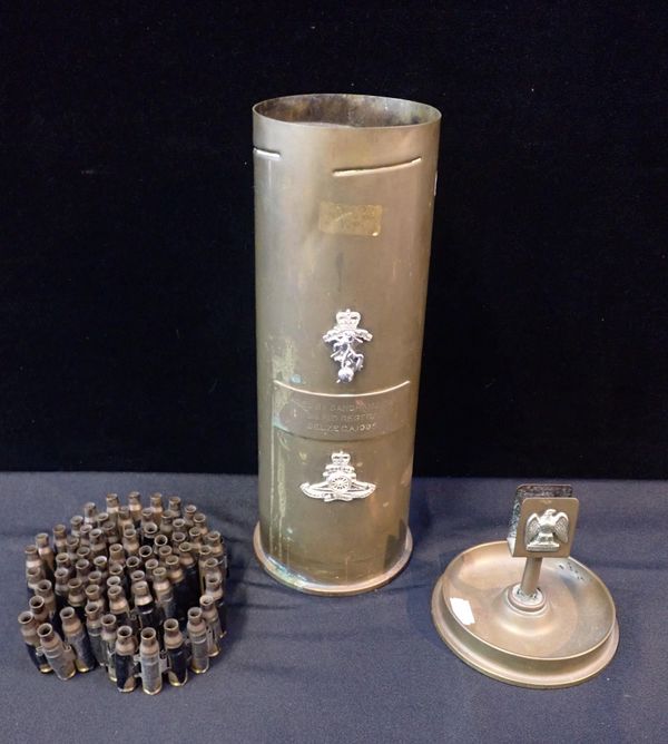 A 105mm SHELL CASE 'FIRED BY SANDHAMS COY