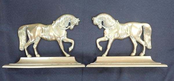 A PAIR OF BRASS HORSE DOOR STOPS