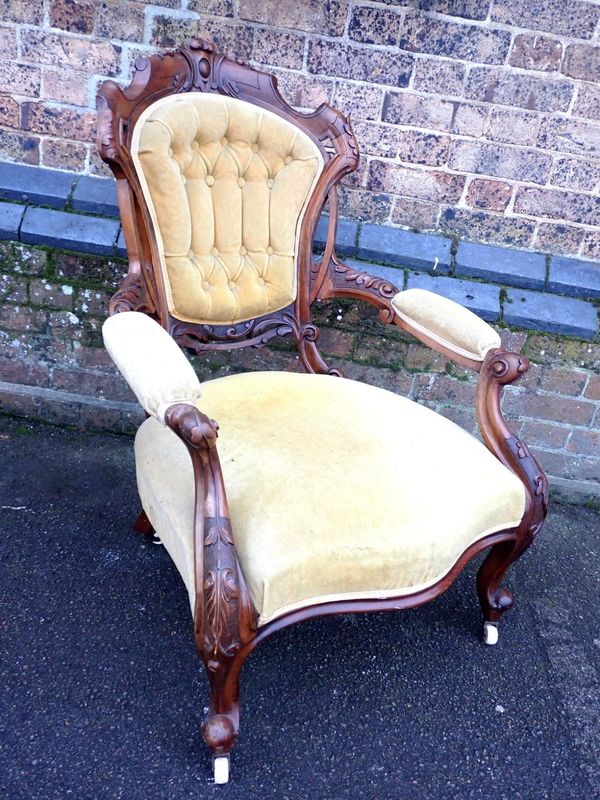 A VICTORIAN WALNUT OPEN ARMCHAIR