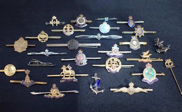 A COLLECTION OF MILITARY BADGE TIE PINS