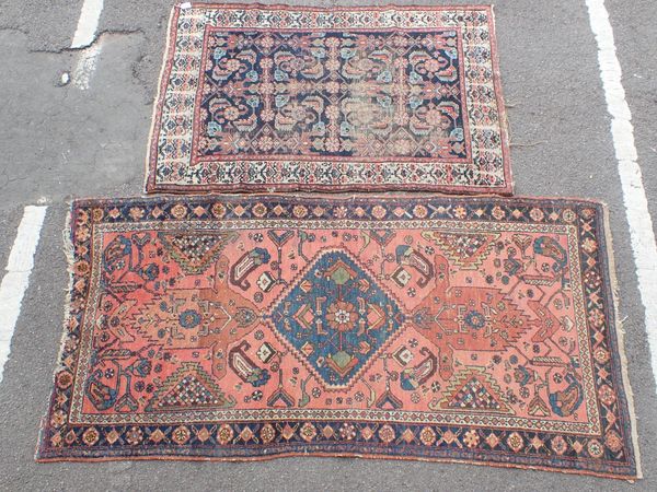 TWO TRIBAL RUGS, THE LARGER RED GROUND