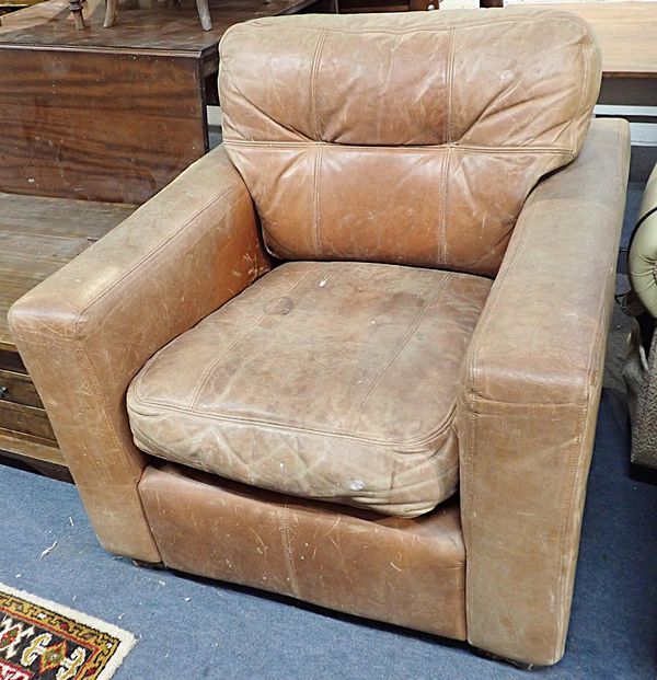 A MODERN PATINATED LEATHER ARMCHAIR