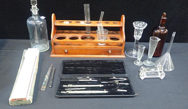 A WOODEN RACK FOR CHEMICAL GLASSWARE, MADE BY ARNOLD & SONS