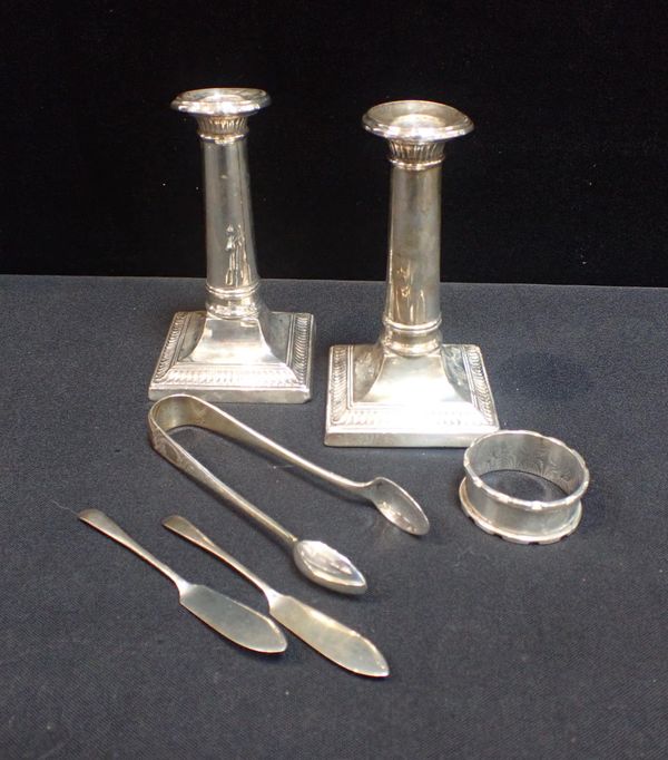 A PAIR OF FILLED SILVER COLUMN CANDLESTICKS
