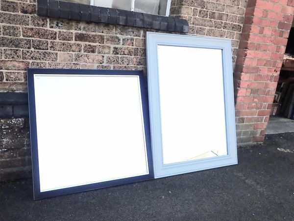 A LARGE GREY FRAMED MIRROR