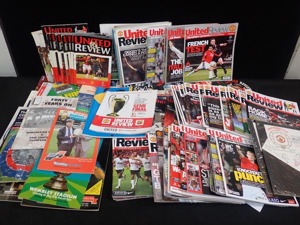 A LARGE QUANITY OF MANCHESTER UNITED FOOTBALL PROGRAMES