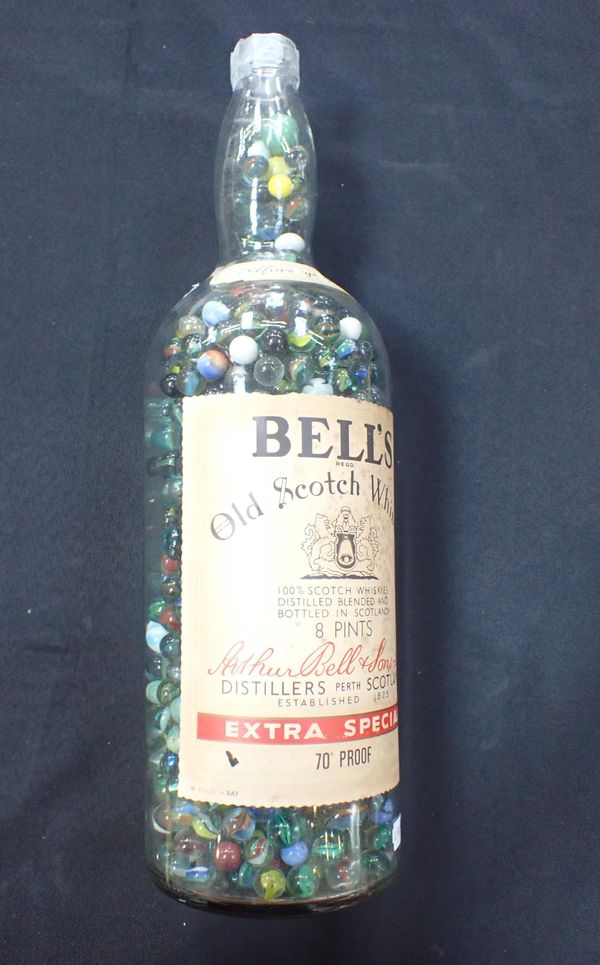 AN 8-PINT BELL'S WHISKY BOTTLE FULL OF GLASS MARBLES