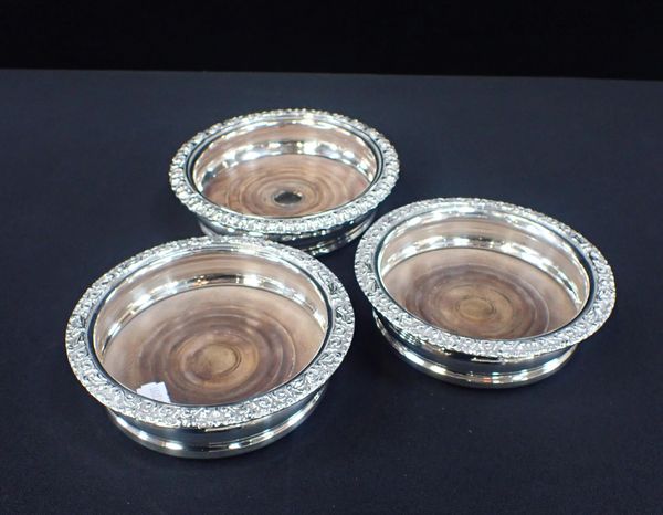 A PAIR OF SILVER-PLATED ON COPPER BOTTLE COASTERS