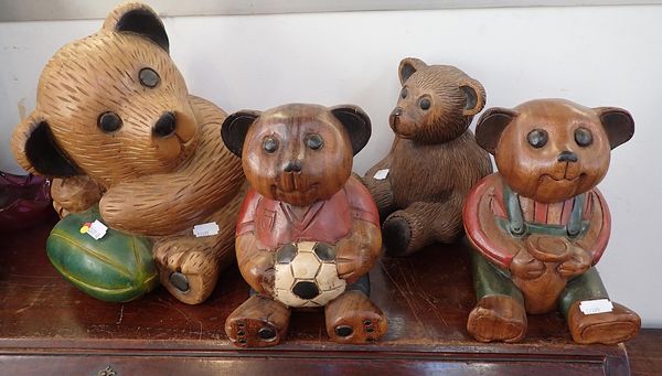 A GROUP OF FOUR CARVED WOOD TEDDY BEARS