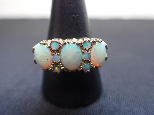 A THREE STONE OPAL 9ct GOLD RING