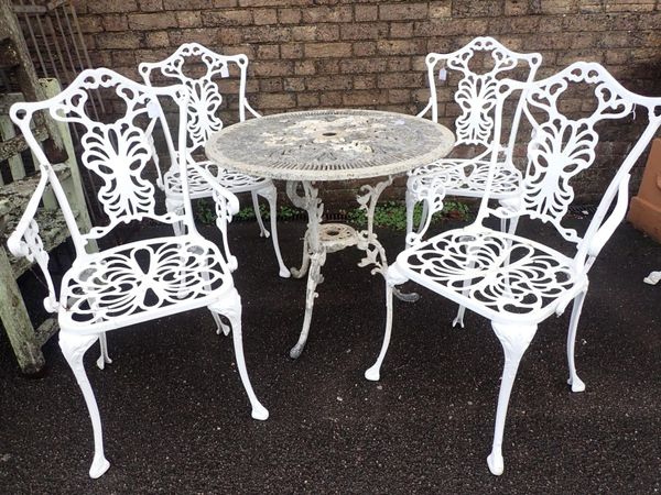 A CAST ALUMINIUM GARDEN TABLE AND FOUR ARMCHAIRS