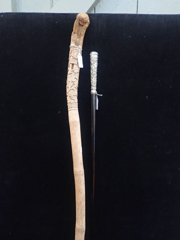A WALKING CANE WITH KUTCH STYLE SILVER-PLATED HANDLE
