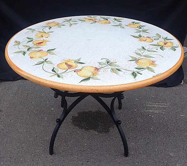 A MEDITERRANEAN CERAMIC TOPPED CIRCULAR DINING TABLE