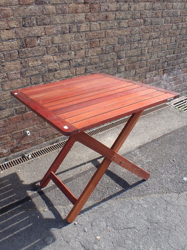 A FOLDING TEAK GARDEN TABLE