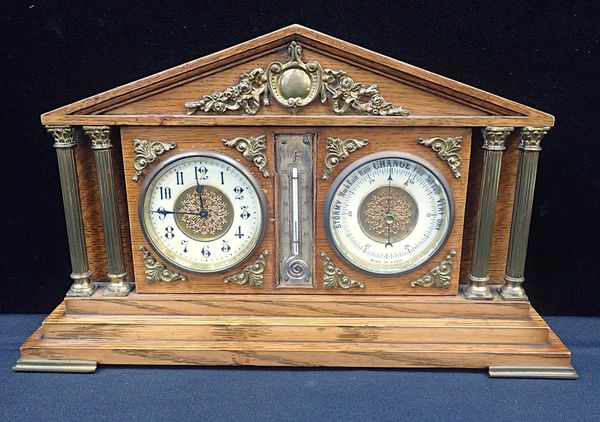 AN EDWARDIAN OAK DESK CLOCK, THERMOMETER AND BAROMETER