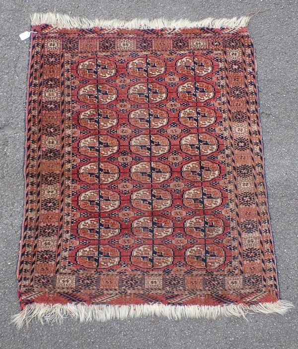 AN OLD RED GROUND BOKHARA RUG