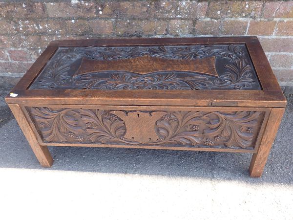 A CARVED OAK CHEST