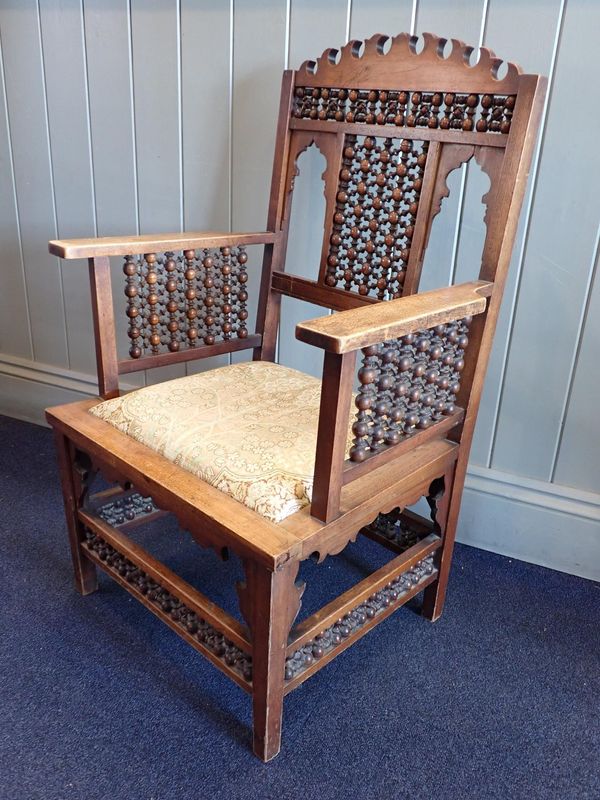 IN THE STYLE OF LEONARD WYBURD FOR LIBERTY & Co, A MOORISH ARMCHAIR