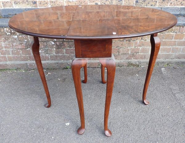 A FIGURED WALMUT DROP LEAF TABLE