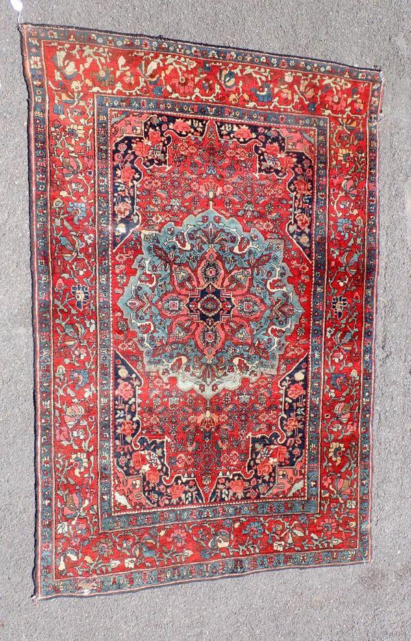 A RED GROUND PERSIAN RUG