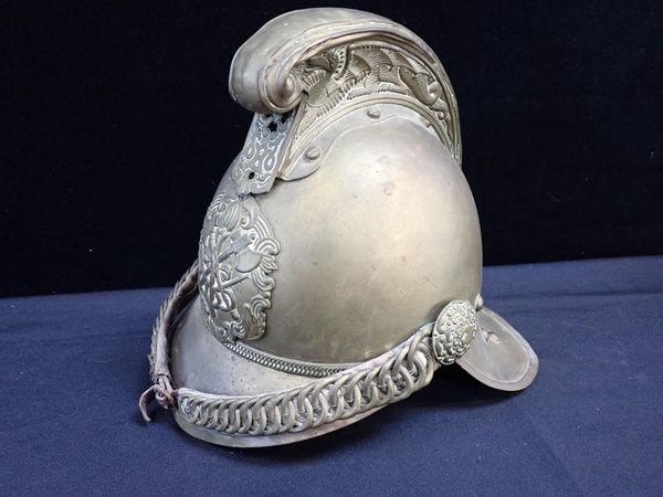 AN OLD BRASS FIREMAN'S HELMET