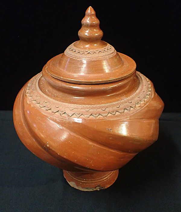 A NORTH AFRICAN TERRACOTTA VASE AND COVER