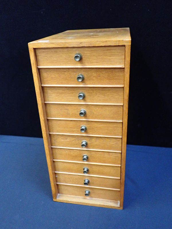 A SMALL OAK-FRONTED BANK OF SPECIMEN DRAWERS