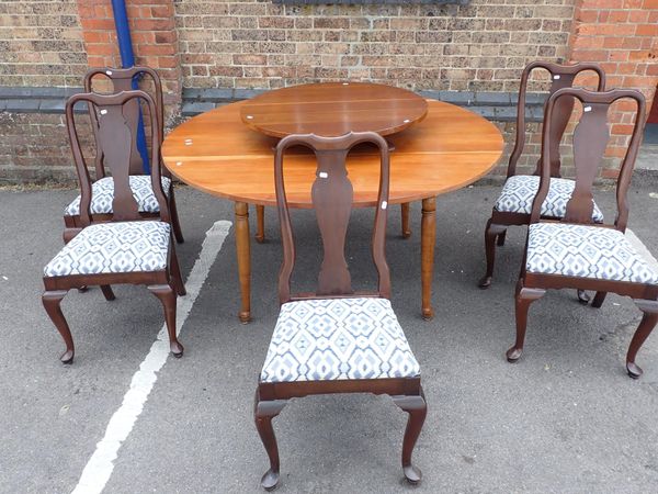 A LARGE CHERRYWOOD CIRCULAR DINING TABLE