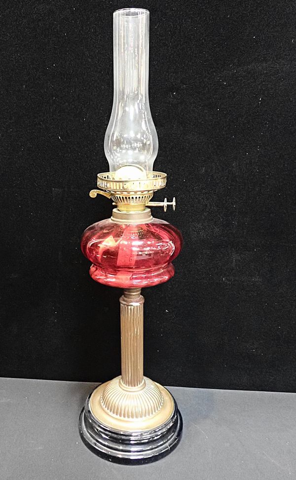 A VICTORIAN OIL LAMP, WITH CRANBERRY GLASS RESERVOIR