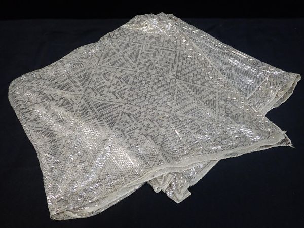 AN EGYPTIAN ASSUIT SHAWL EXTENSIVELY WOVEN WITH WHITE METAL