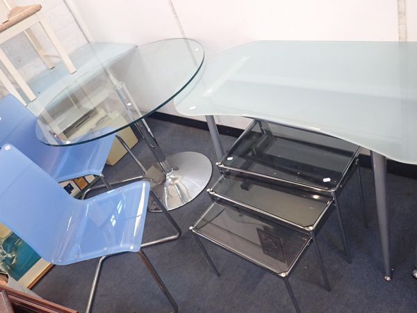 A MODERN GLASS-TOPPED TABLE ON METAL COLUMN