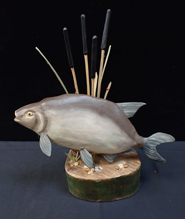 A MODERN LEAPING SALMON WOOD SCULPTURE