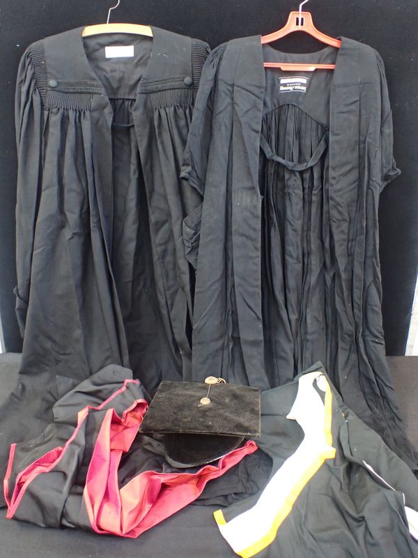 TWO ACADEMIC GOWNS AND A MORTAR BOARD