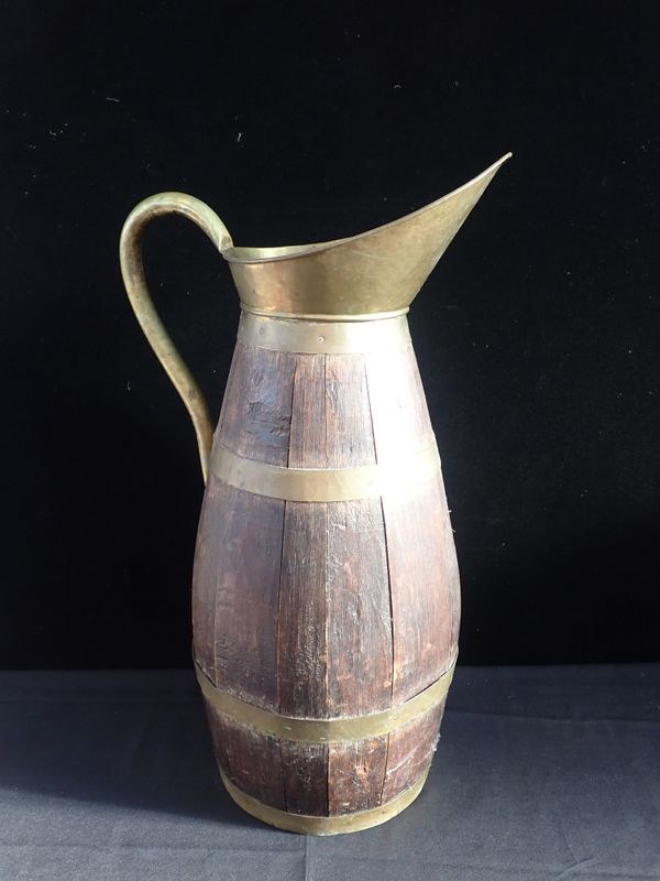 A LARGE WOODEN COOPERED BARREL JUG