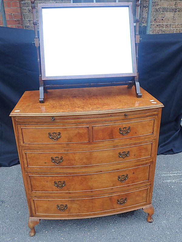 A WALNUT BOWFRONT CHEST OF DRAWERS