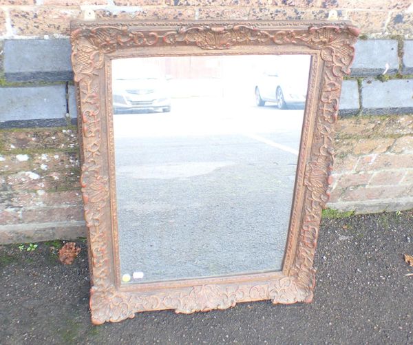 A GILT FRAMED MIRROR