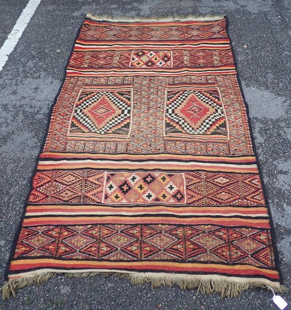 A FLAT-WEAVE RUG, PURCHASED IN THE CAMEROONS