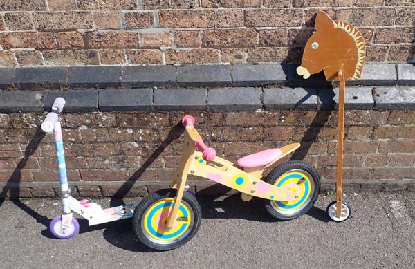 A TODDLER'S WOODEN BALANCE BICYCLE