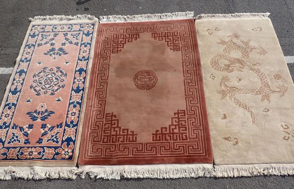 A CHINESE RUG WITH DRAGON DESIGN ON CREAM GROUND