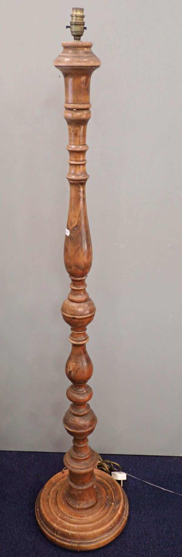 A TURNED WOODEN STANDARD LAMP