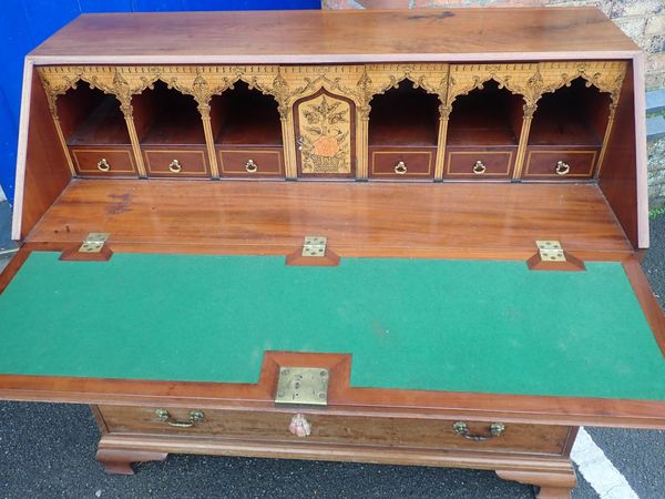 A GEORGE III MAHOGANY BUREAU WITH HOLLY VENEERED AND PENWORK DECORATED ARCADE