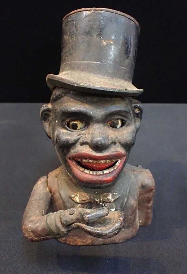 A CAST IRON AMERICAN NOVELTY MONEY BOX