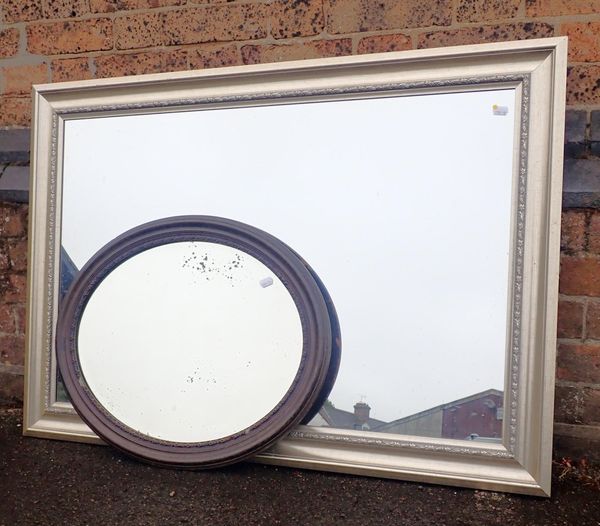 A LARGE WALL MIRROR WITH SILVERED FRAME