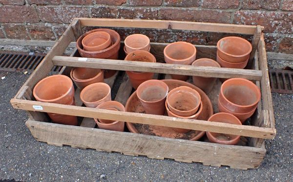 A WOODEN CRATE CONTAINING OLD TERRACOTTA FLOWERPOTS